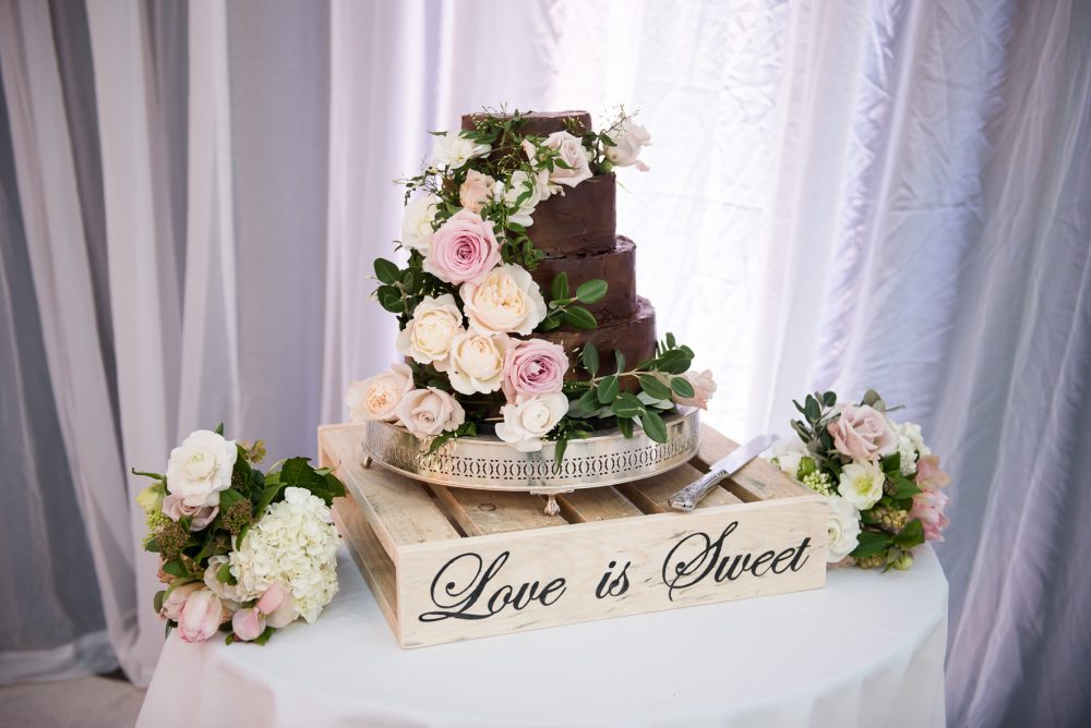 Chocolate wedding cake with real flower decoration