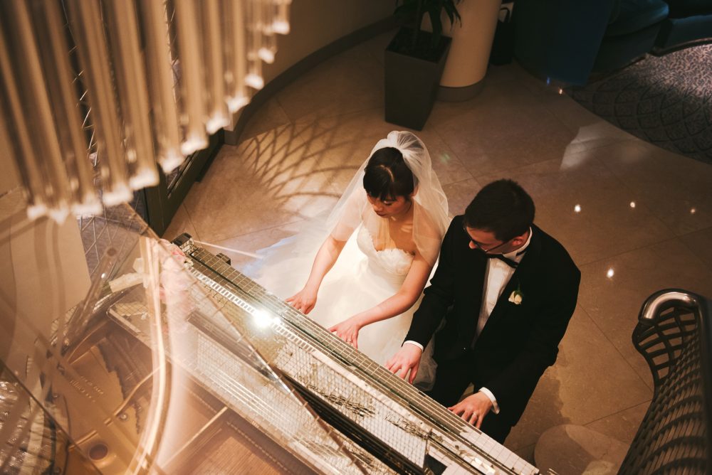 Bride and groom play Liberace's piano
