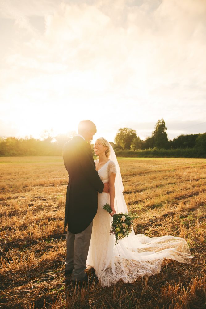 Bride and groom in a field of barley