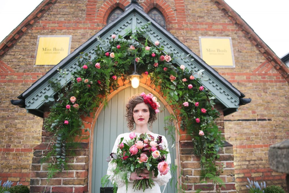 Chloe Keenan wears Houton Bentley wedding dress with red ranunculus and purple tulip spring bouquet.