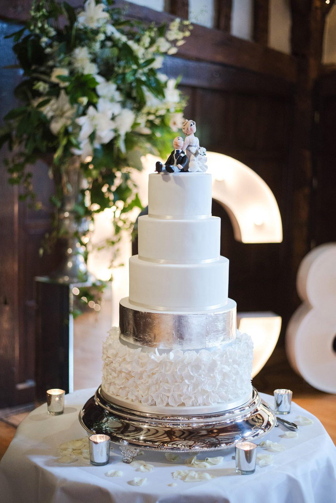 Silver and white wedding cake for a tithe barn wedding in Surrey.