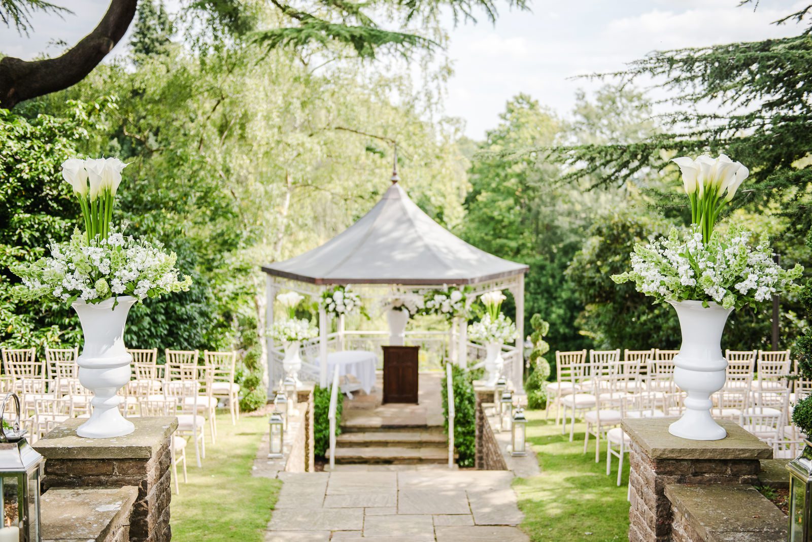 Elegant outdoor pavilion decorated with white lilies and stocks for a same sex Summer wedding in Surrey.