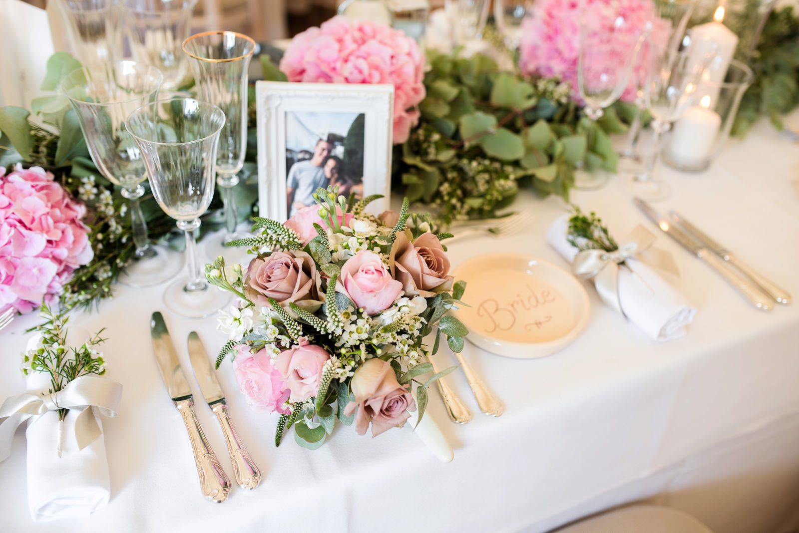 Beautiful pink rose and white wax flower table setting for a Berkshire marquee Summer wedding.