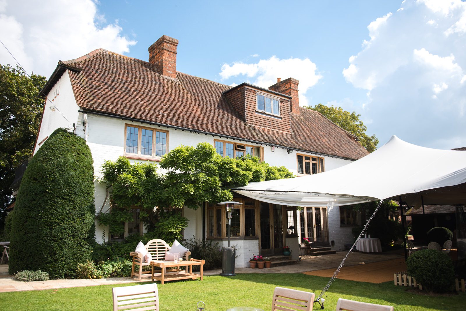 Luxury Berkshire home wedding day with comfy cushions and sun and rain canopy.