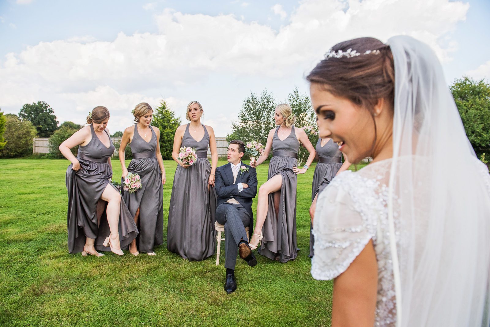 The groom with the bridesmaids in an alternative group shot for a Berkshire wedding.