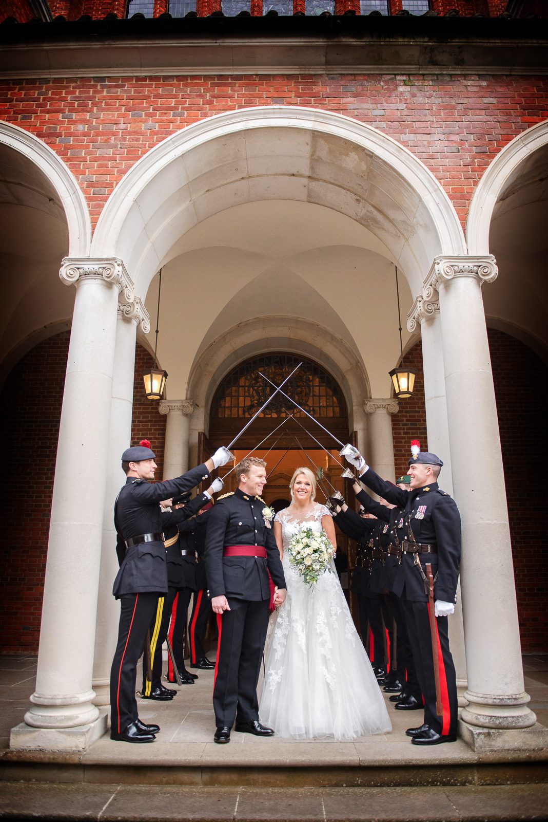 A military guard of honour for a bride and groom as they leave the chapel at the Royal Military Academy Sandhurst following their wedding ceremony.