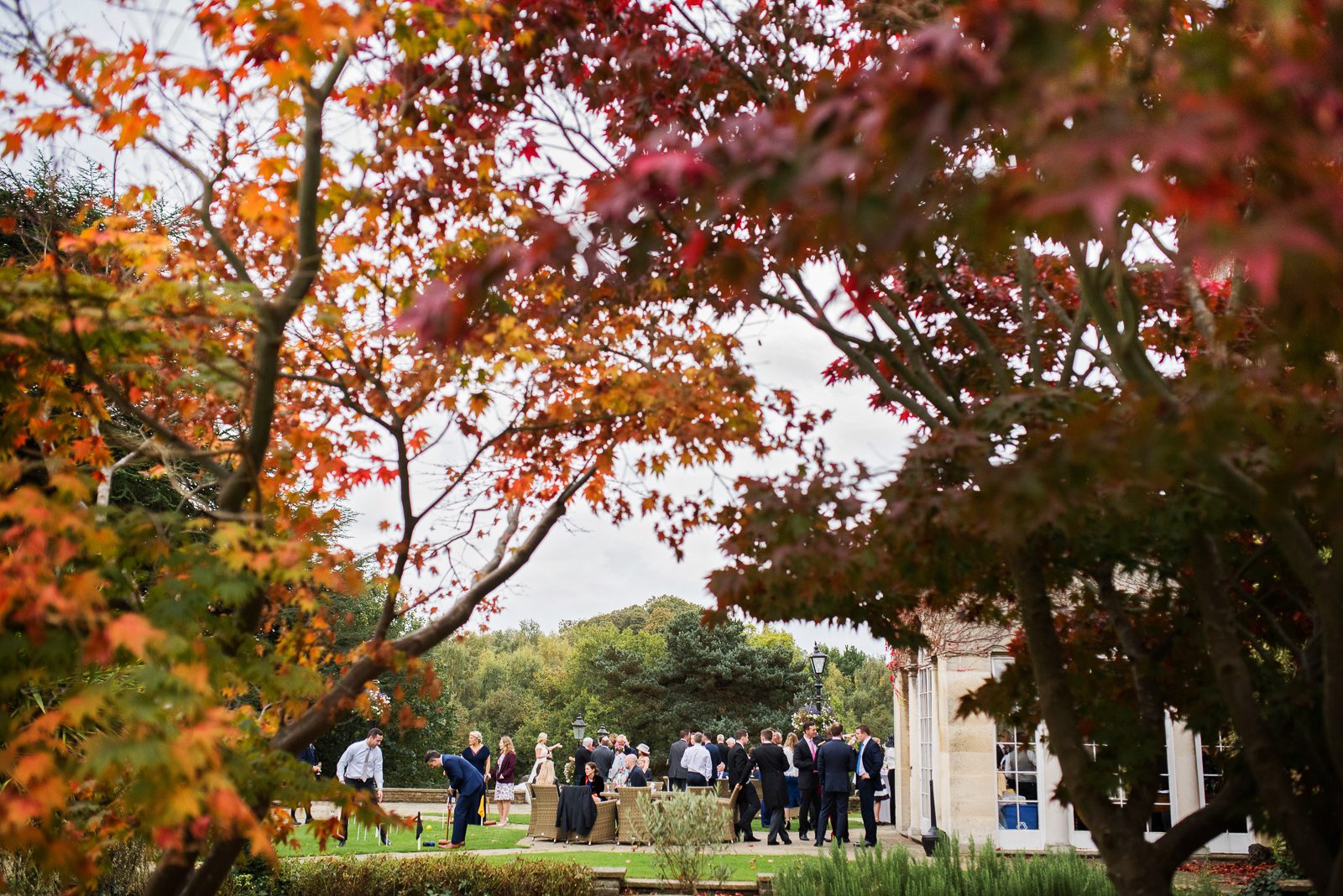Photos of an Autumn wedding at pennyhill park during the outdoor reception with drinks and canapés on the terrace.