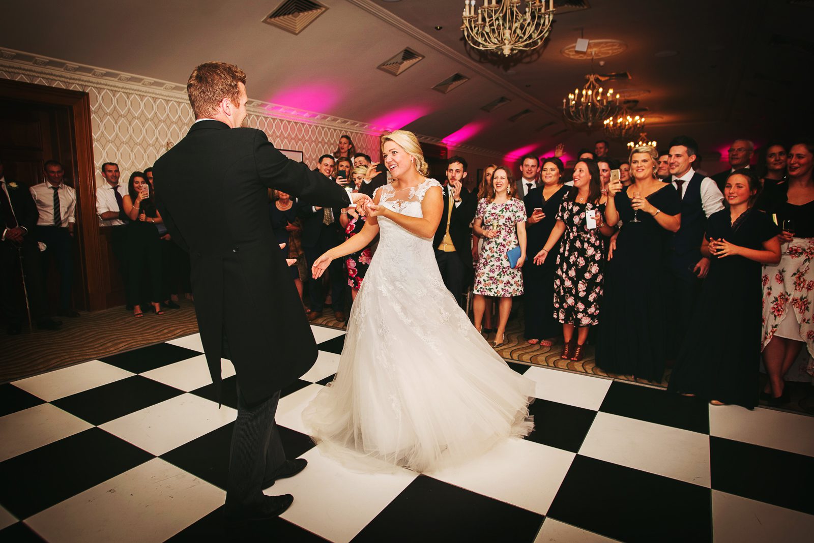 Documentary wedding photo of the bride and groom dancing at Pennyhill park.