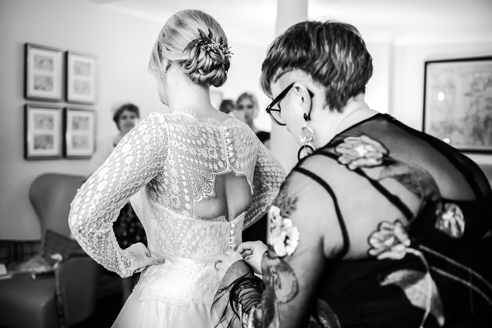 Black and white candid photography of bride getting ready for her wedding.