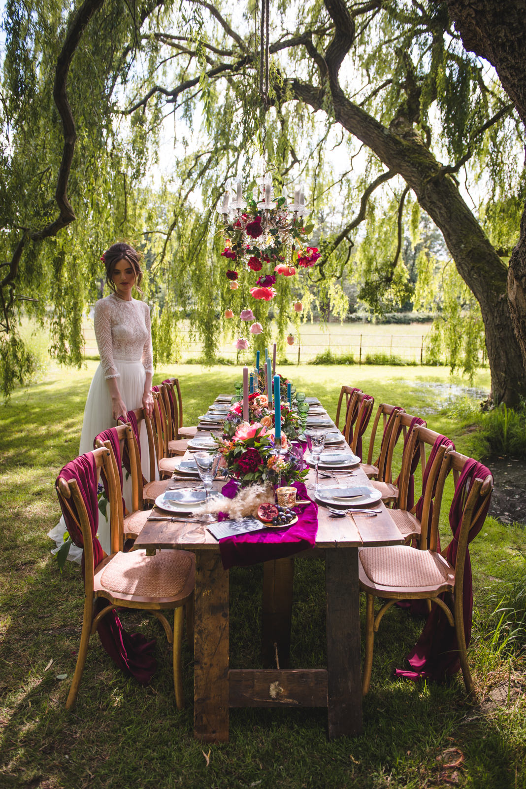 Decedent intimate wedding breakfast table in a meadow setting.