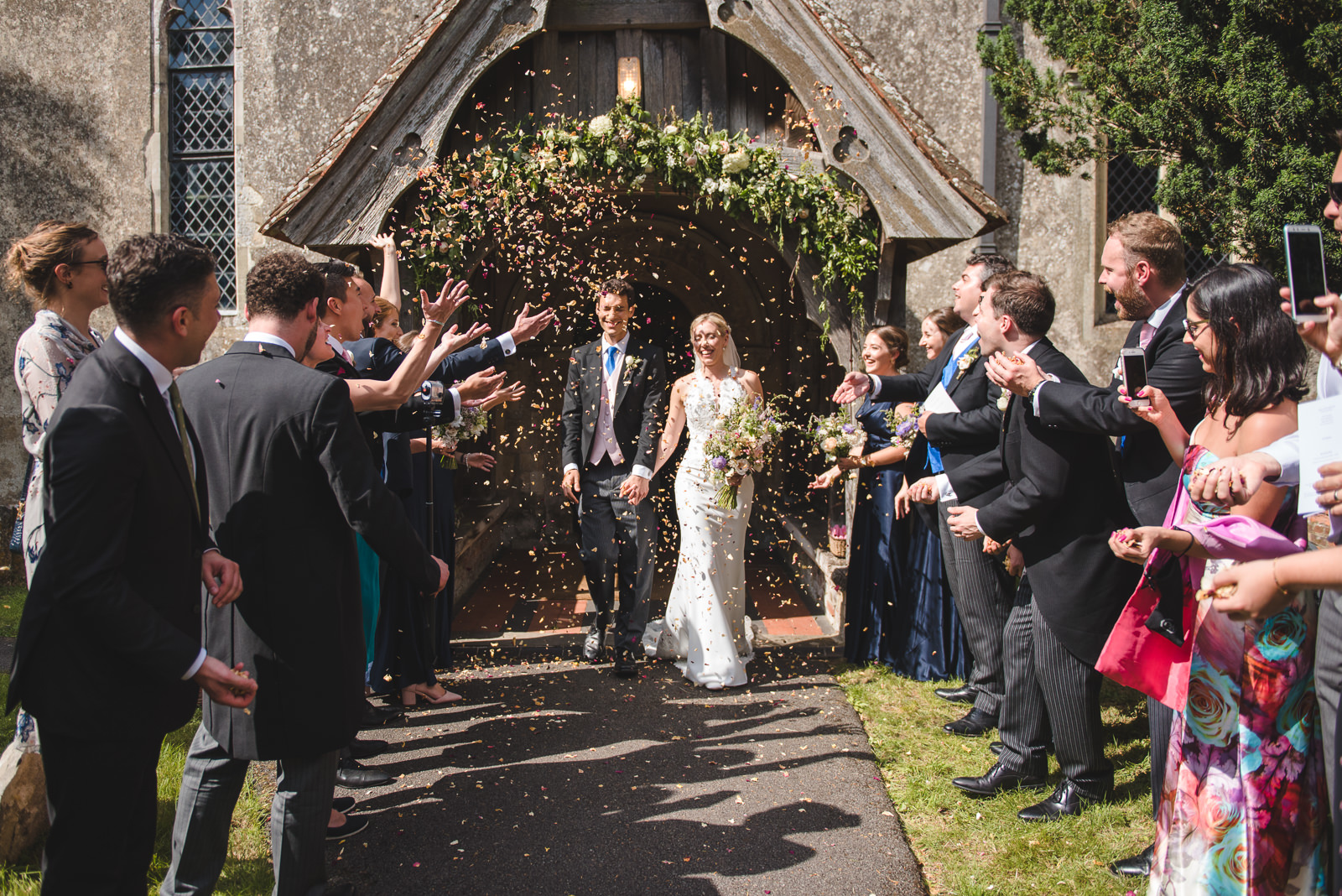 Throwing confetti after a village church wedding.