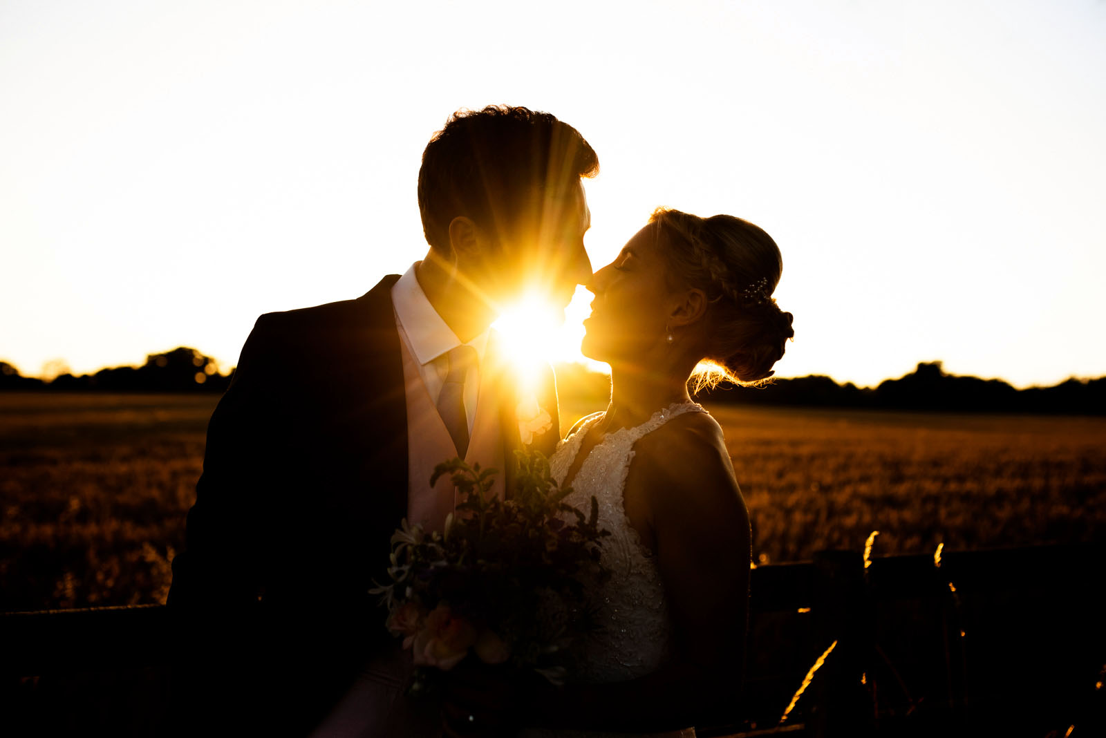 Backlit bride and groom photos at sunset.
