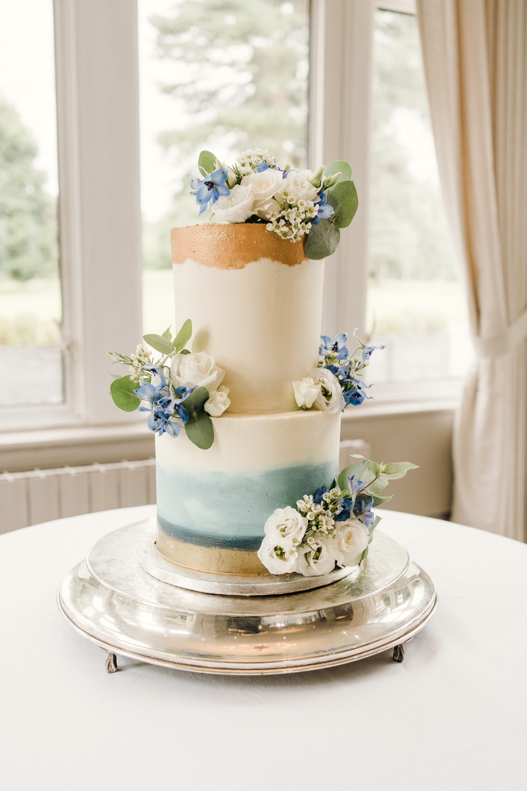 Hand painted cake for a blue themed wedding.