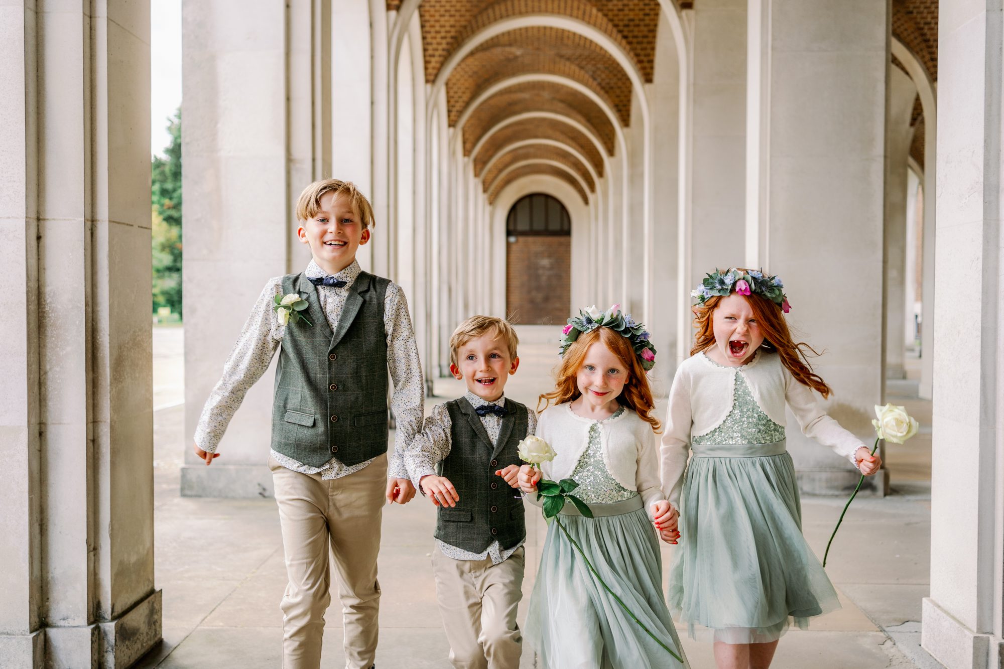 Relaxed and joyful page boy and bridesmaids at Hertford registry offices.