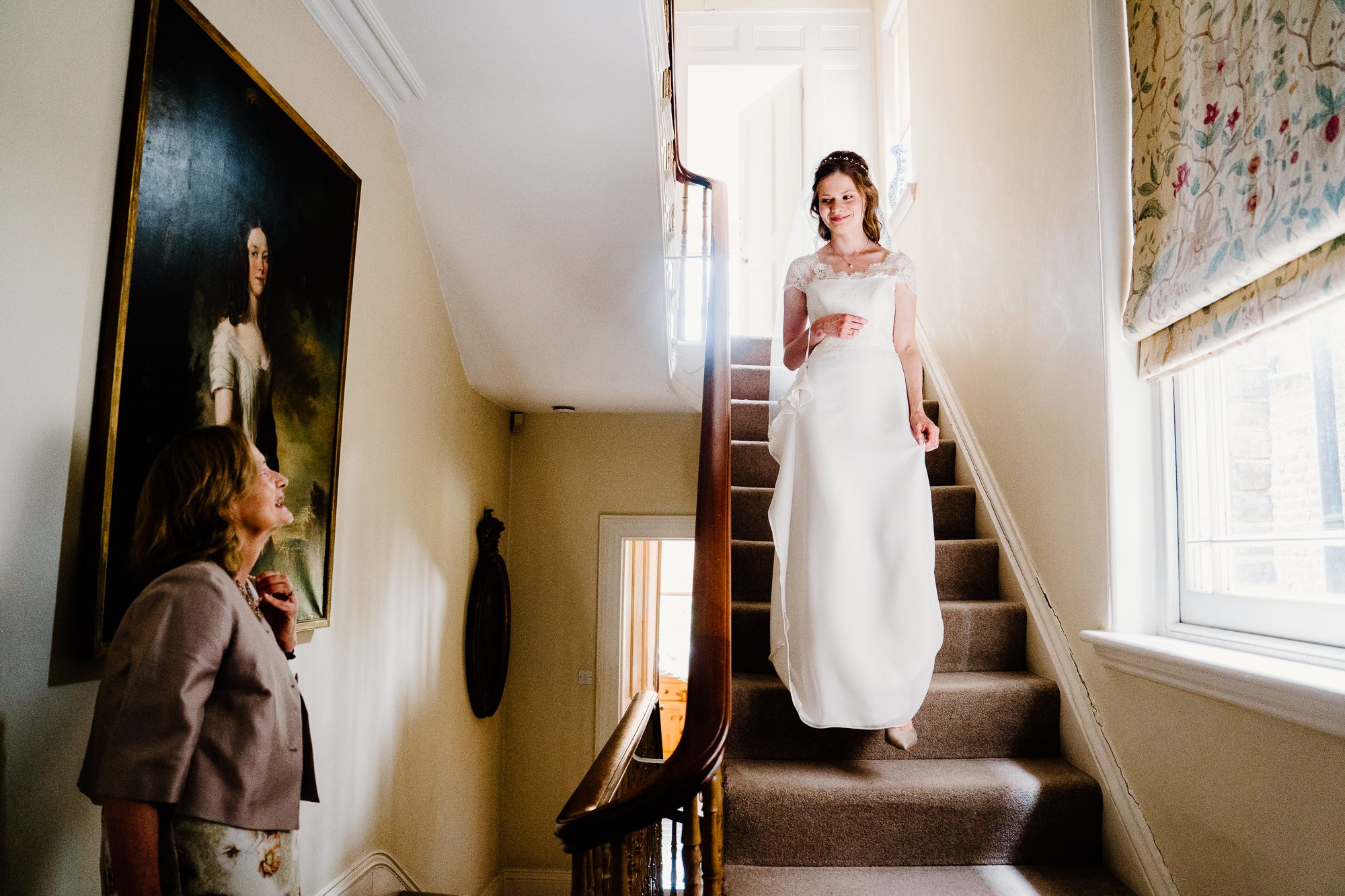 Mother of the bride sees her daughter in her wedding dress. Classic wedding photography moments.