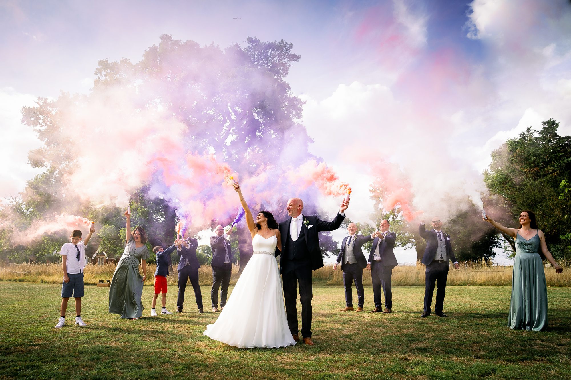 Summer wedding with bride and groom smoke bomb photographs.