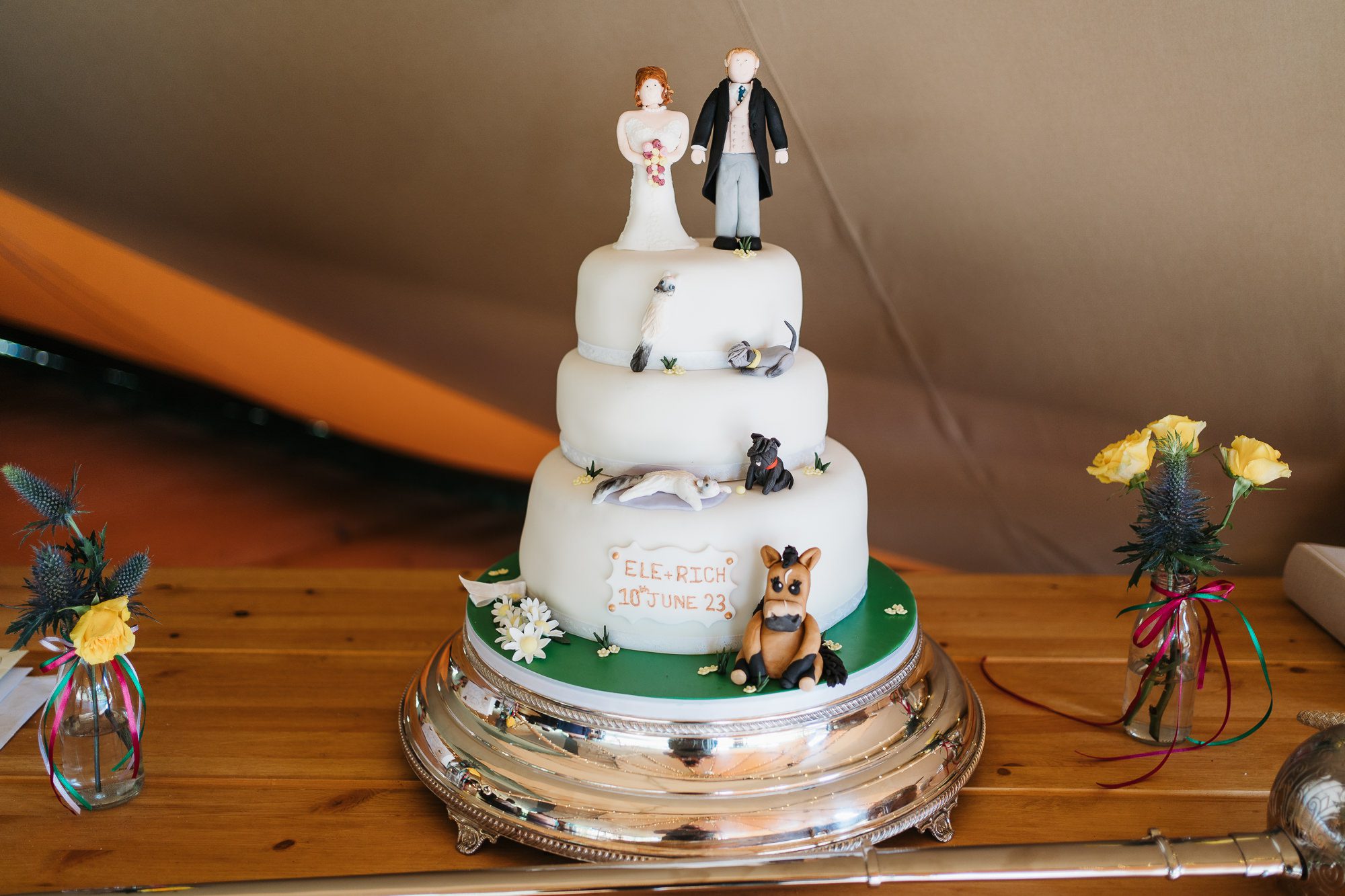 Handmade wedding cake featuring the bride and groom's pets.
